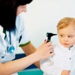 Lekarka badająca słuch u małego dziecka otoskopem – diagnostyka słuchu w gabinecie specjalisty